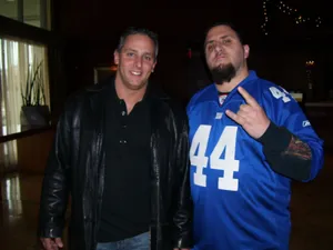 Two Men Posing Indoors Wallpaper