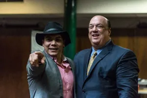 Two Men Smiling With One Pointing Wallpaper