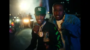 Two Men Standing Next To Each Other At Night Wallpaper