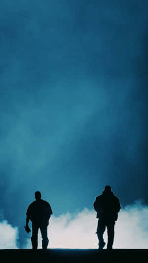 Two People Standing On A Hill Wallpaper