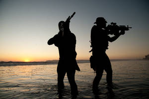Two U S Navy Seals Standing On Water Wallpaper