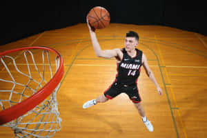 Tyler Herro Of The Miami Heat Slam Dunking The Ball Wallpaper