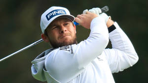 Tyrrell Hatton In Action At A Golf Tournament Wallpaper