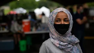 U.s. Congresswoman Ilhan Omar Wearing Black Mask Wallpaper