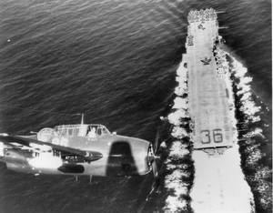 U S Navy Plane Flying Above A Carrier Wallpaper