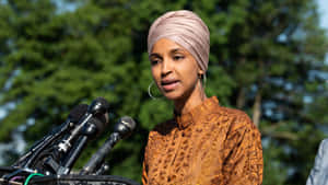 U.s. Representative Ilhan Omar Exudes Elegance And Confidence Wallpaper