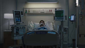 Unconscious Patient On Hospital Bed Wallpaper