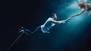 Underwater_ Rescue_ Dramatic_ Reaching Wallpaper