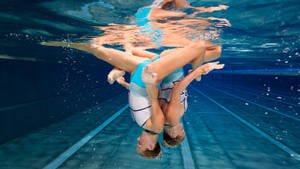 Unparalleled Synchrony In Artistic Swimming Wallpaper