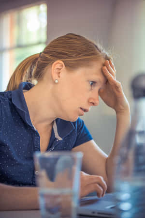 Upset Man Leaning Against Wall Wallpaper