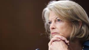 Us Senator Lisa Murkowski In A Deep Contemplative Gesture Wallpaper