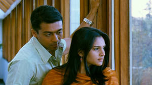 Vaaranam Aayiram Krishnan And Simran Standing By A Window Wallpaper