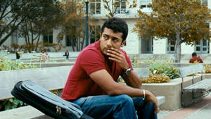 Vaaranam Aayiram Surya Sitting On A Bench Wallpaper