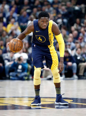 Victor Oladipo In Yellow Blue Jersey Wallpaper