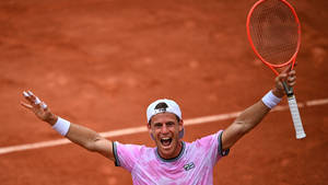 Victorious Moment: Diego Schwartzman Celebrating A Win Wallpaper