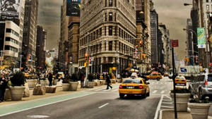 View Of A Bustling New York City Street Wallpaper