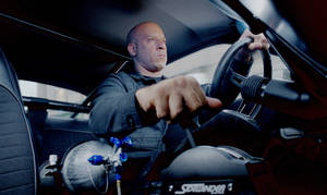 Vin Diesel Driving As Toretto Wallpaper