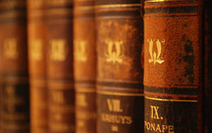 Vintage Books Arranged With Brown Book Cover Wallpaper