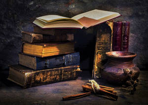 Vintage Bowl Accompanied By Aged Books Wallpaper