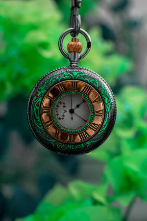 Vintage Elegance - Antique Clock On A Green Background Wallpaper