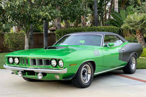 Vintage Plymouth Barracuda On Road Wallpaper