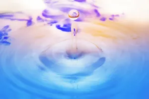 Vivid Strains Of Life: A Colorful Water Droplet Wallpaper