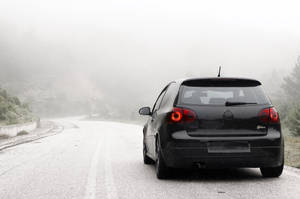 Volkswagen Golf Gti Driving Through Snow Wallpaper