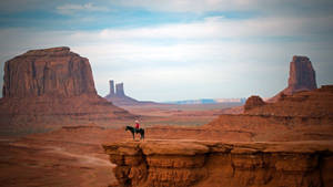 Western Cowboy On A Cliff Wallpaper