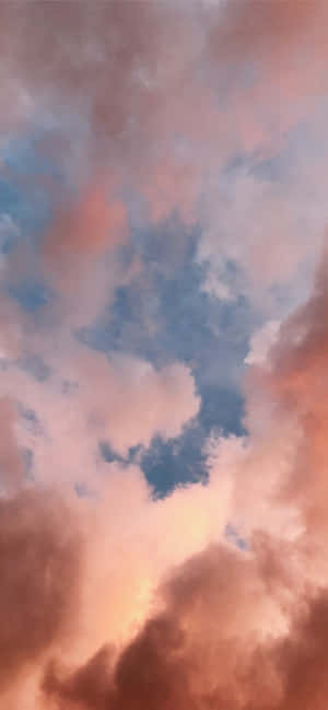 White Clouds Blanketing A Vast, Clear Blue Sky Wallpaper