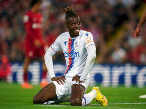 Wilfried Zaha Kneeling On Ground Wallpaper