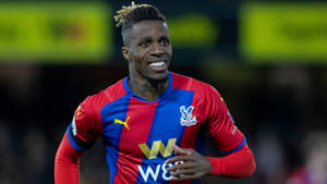 Wilfried Zaha Smiling While Running Wallpaper