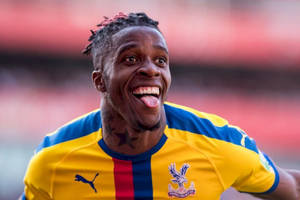 Wilfried Zaha Sticking His Tongue Out Wallpaper