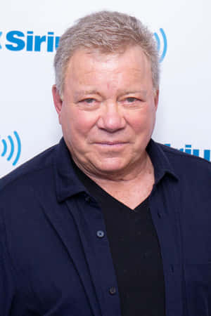 William Shatner Posing In A Blue Blazer Wallpaper