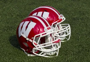 Wisconsin Badgers Football Team Charging Onto The Field Wallpaper