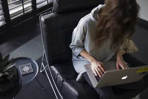 Woman Editing On Her Laptop Wallpaper