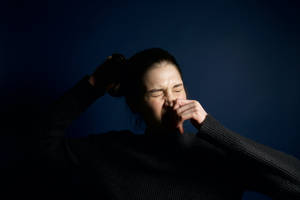 Woman Holding Sneeze Wallpaper