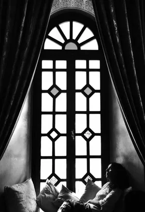 Woman Relaxing By The Window Wallpaper