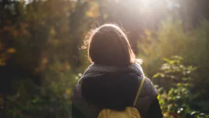 Woman's Woodland Journey Wallpaper