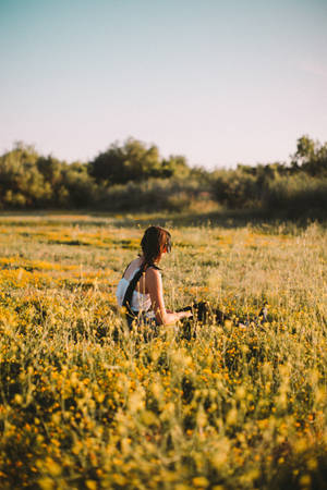 Woman Sitting On Meadow Wallpaper