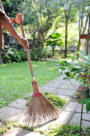 Woman Sweeping Backyard - A Domestic Cleaning Endeavour Wallpaper