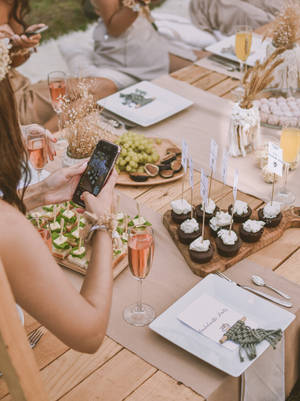 Woman Taking Photo Of Bachelorette Party Food Wallpaper