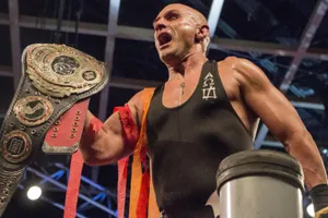 Wrestler Champion Belt Victory Pose Wallpaper