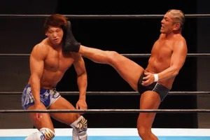 Wrestler Minoru Suzuki Lethal Kick On Kota Ibushi In The Ring Wallpaper
