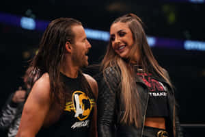 Wrestling Personality Adam Cole Posing With Britt Baker Wallpaper