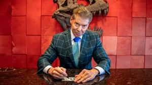 Wwe Ceo Vince Mcmahon Signing A Check Wallpaper