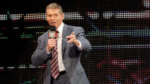 Wwe Commentator Vince Mcmahon Holding A Mic Wallpaper