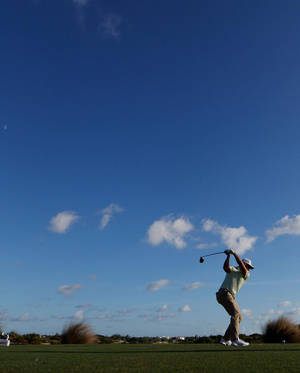 Xander Schauffele Golf Swing Wide Shot Wallpaper