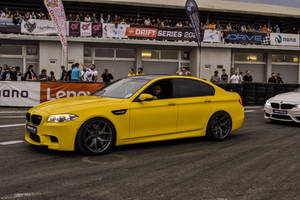 Yellow Bmw M5 At Racing Track Wallpaper