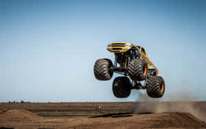 Yellow Monster Truck Going Upwards Wallpaper