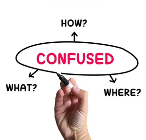 Young Man Standing At A Crossroads, Looking Lost And Confused. Wallpaper